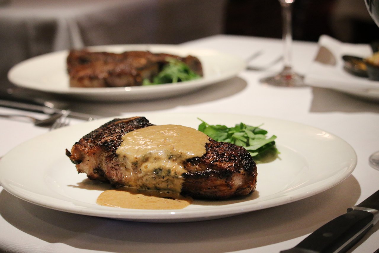 The Capital Grille signature dishes Dry Aged NY Strip Au Poivre with Courvoisier Cream
Seared Salmon With Avocado, Mango And Tomato Salad With Champagne Vinaigrette
Filet Mignon 10oz